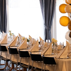 Opdækket festlokale med guld balloner